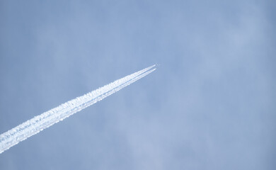 double trail in the sky of an airplane