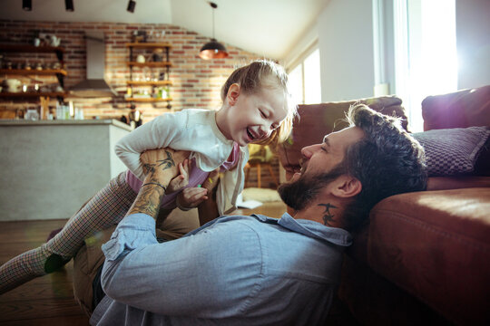 Father and daughter enjoying playtime and laughing at home