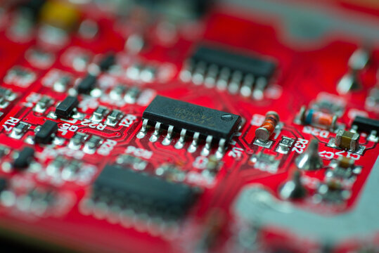 red electronic circuit board with black ic