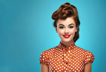 Beautiful Retro Girl model in a vintage dress with polka dots smiles on a blue background for an advertising banner