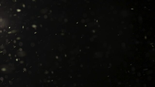 Abstract background with snow flakes falling from the sky in the night time