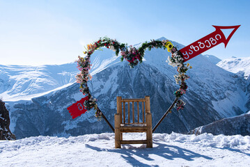 Flower with heart shape back is view of Caucasus mountain range Georgia