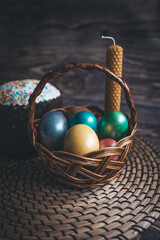Still life Easter eggs and Easter cake on the table. The concept of home comfort in the bright holiday of Easter.