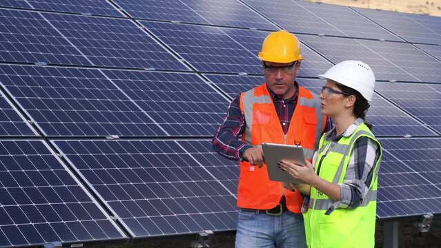 Solar panels, handshake and people partnership, collaboration or thank you for installation of green energy power. Young adult engineer inspect installation of solar panels installed.