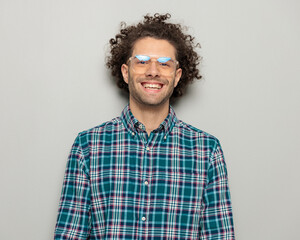 portrait of excited casual man with glasses being happy and laughing