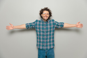 happy casual man with glasses opening arms and giving a hug