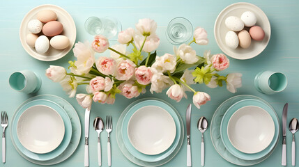 Easter table setting with eggs and flowers on blue
