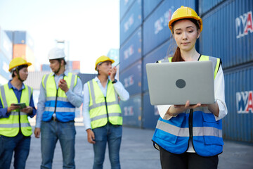 factory worker or engineer working on laptop computer in containers warehouse storage