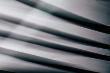Abstract horizontal striped background with smooth lines and highlights in black and gray tones.