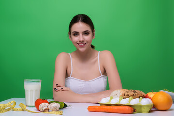 Obraz na płótnie Canvas Vegetables diet. Young woman eating healthy food, dieting. Girl eating vegetable diet salad in studio. Vegan salad. Female on diet. Dieting concept. Healthy lifestyle. Diet for weight loss.