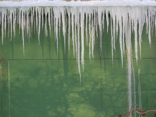 Icecles hanging from a roof.