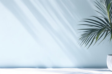 Fototapeta na wymiar Minimalistic light background with blurred shadow of foliage on light blue wall.