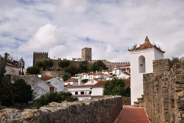 Fototapeta na wymiar View of the city of Óbidos with castle walls and a small bell tower
