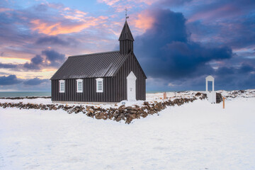 The little black church of Budir, Black Church. South coast of Snaefellsnes peninsula In the West of Winter Iceland - obrazy, fototapety, plakaty