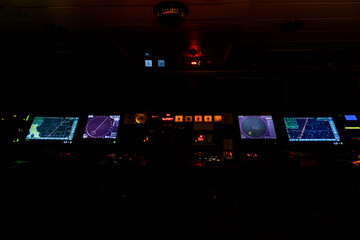 Navigational bridge on big cargo ship. Wheelhouse on vessel. ECDIS, radar. Night time. © Alexey Seafarer
