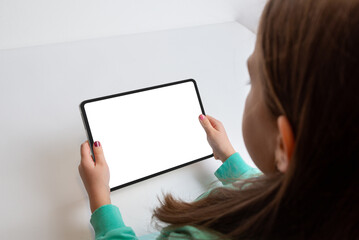 Girl watching a movie on a tablet in a horizontal position at her work desk. Isolated screen for...