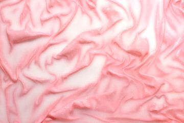 Thin, delicate summer clothes soaked in water with detergent, fine laundry, creative pastel pink background.