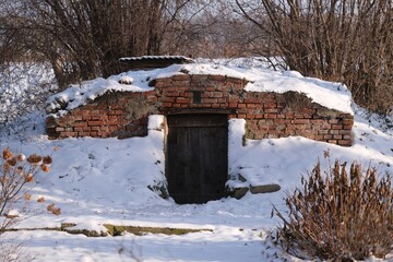 A brick cellar in the countryside in a winter scenery