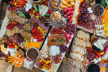 Slices appetizers on wood trays and long white plates. Party finger food.