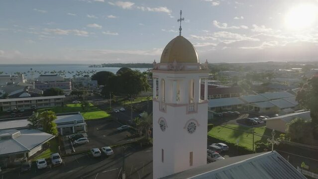 another sunrise flying counter clockwise around church tower in Hilo Hawaii