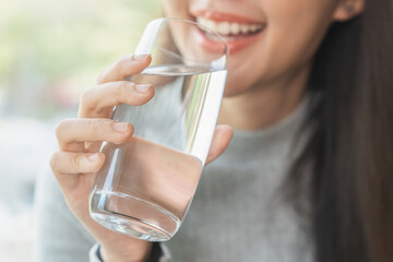 Happy beautiful, asian young woman, girl drinking, sip fresh glass of water for hydration of body,...