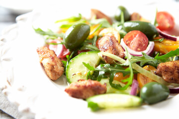Healthy Salad with Chicken Breast, Cherry Tomatoes, Cucumber, Rocket and Green Olives. Close up.
