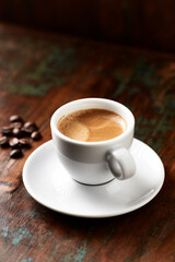 Cup of coffee on wooden background. Close up.