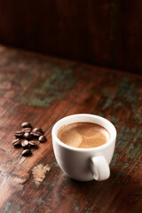  Cup of coffee on wooden background. Close up.