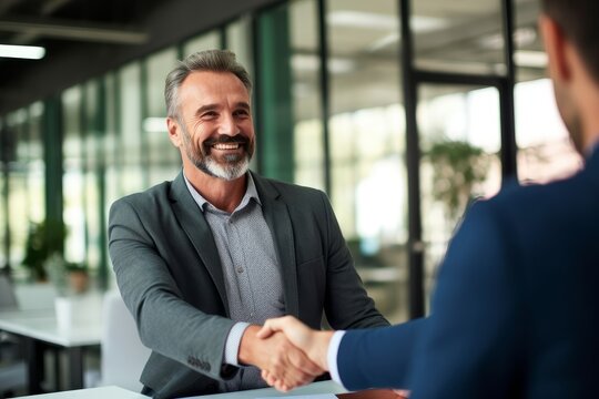 Smiling middle aged business man handshaking partner making partnership collaboration agreement at office meeting, hr manager and new worker shake hands recruiting at job interview. Generative AI