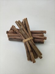 pile of brown dry wood pieces on white background