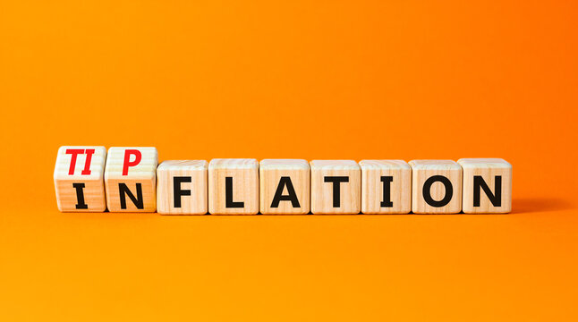 Inflation or tipflation symbol. Concept words Inflation Tipflation on beautiful wooden blocks. Beautiful orange table orange background. Business inflation Tipflation concept. Copy space