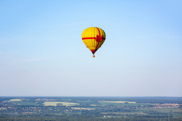 Colorful hot air balloon against the blue sky. Balloon flight. Summer morning.