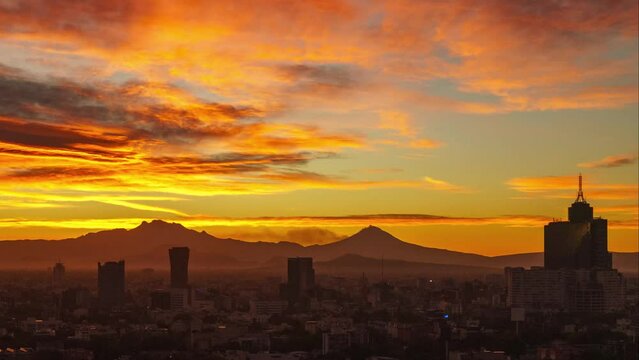 Beautiful and magnificent panoramic view of Mexico City at sunrise over the Popocatépetl and Iztaccíhuatl volcanoes.
