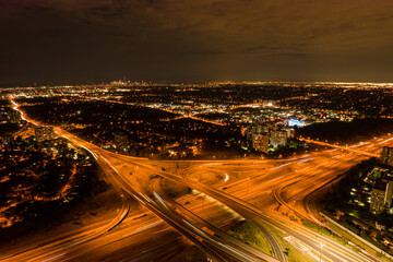 Top view deep night city of car traffic at intersection lane and buildings. Long exposure of urban...