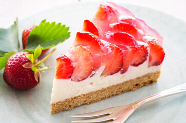 Traditional German strawberry cheese cake piece with fresh fruits served as close-up on a cake plate