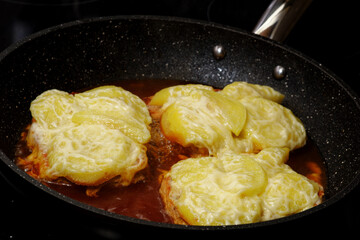 Cooking pork meat with apple and cheese