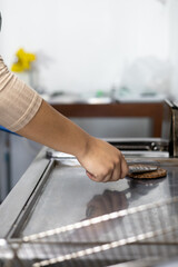 details of cooking meat on a grill, fresh ingredients for fast food, kitchen utensils, detail of food preparation, occupation and restaurant