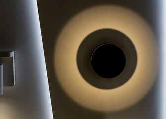 Wall lamp-sconce with circular lighting.