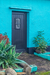 Turquoise house with black door
