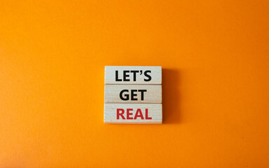 Lets get real symbol. Concept words Lets get real on wooden blocks. Beautiful orange background....