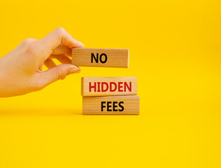 No hidden fees symbol. Concept word No hidden fees on wooden blocks. Businessman hand. Beautiful yellow background. Business and No hidden fees concept. Copy space