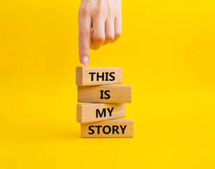 This is my Story symbol. Wooden blocks with words This is my Story. Businessman hand. Beautiful...