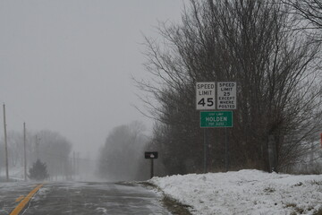 Road Signs by a Snowy Highway
