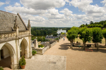 Fototapeta premium Castle in the city of Amboise France, beautiful architecture, old roofs, Loire river, green trees and colorful flowers. 