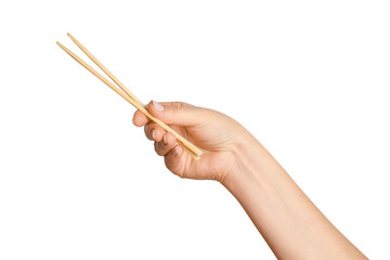 A woman's hand holds wooden chopsticks for sushi or rolls on a blank background.