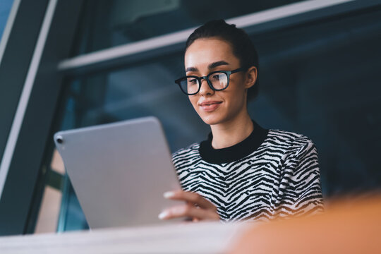 Smiling young woman with tablet in office