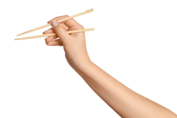 Foto op Canvas A woman's hand holds wooden chopsticks for sushi or rolls on a blank background. © MM
