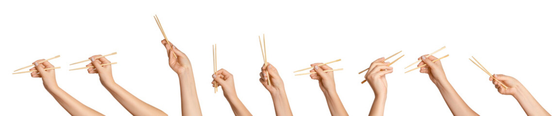 A set of female hands holding wooden chopsticks for sushi or rolls on a blank background.