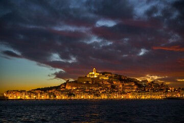 sunset over the city ibiza spain island party old town wide panaromic view cloudy blue hour evening...