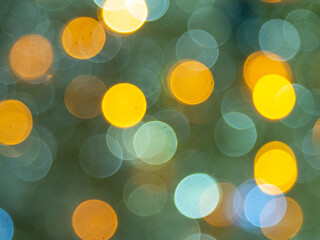 Yellow lights of blinking garland in blur. Unsharp bulbs of Christmas decorations